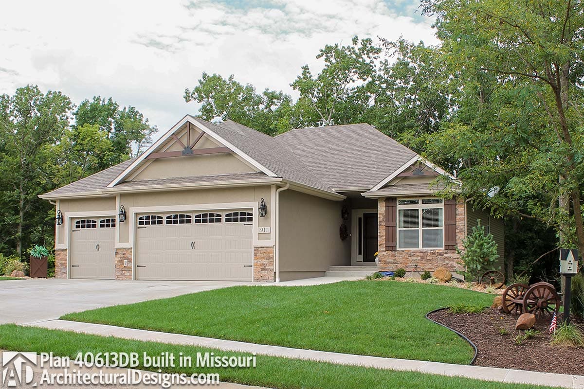 Ranch house plan exterior with three-car garage, stone accents, gabled roof, and decorative gable bracing.