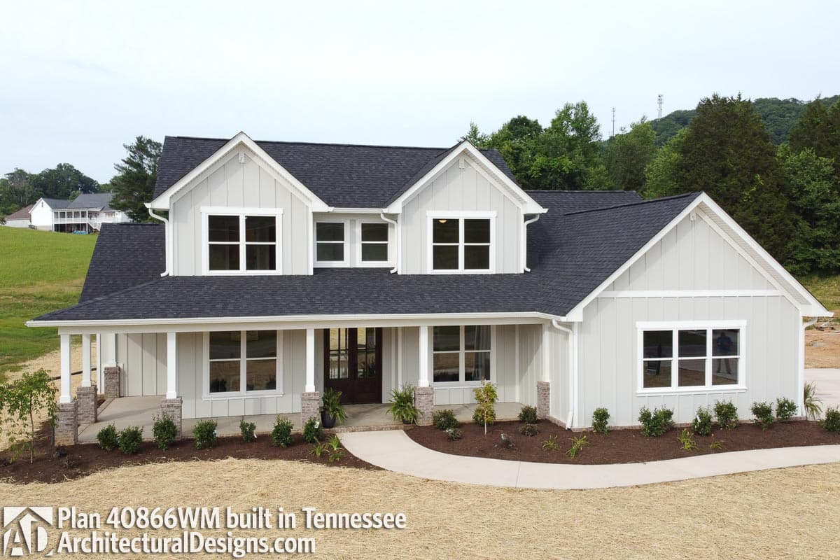 House plan exterior: Two-story Modern Farmhouse with wrap-around porch, board-and-batten siding, and multiple gables.