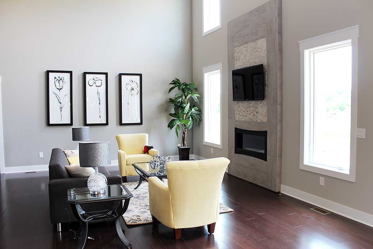 Interior: Great room with vaulted ceiling, fireplace with stone surround, and large windows.