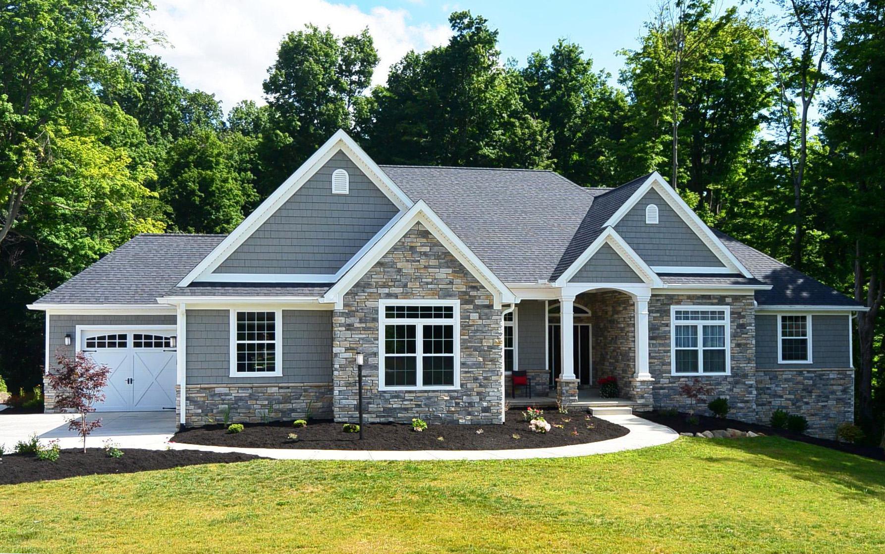 Ranch-style house plan exterior with stone and shingle siding, a covered entry, and a two-car garage.