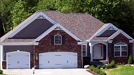House plan exterior: Ranch style, two-car garage, arched windows, and covered entry with white columns.