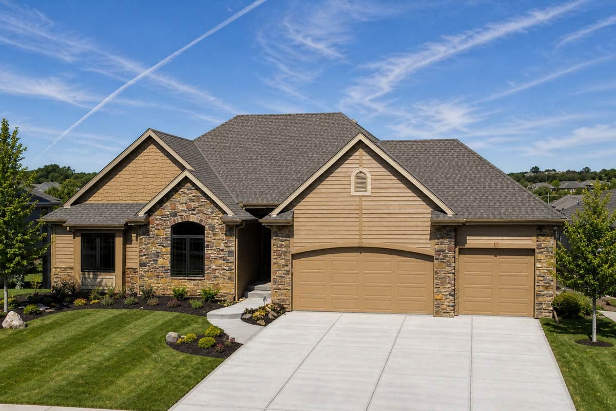 House plan exterior: Ranch style, one-story, stone and vinyl siding, gabled roof, front entry, and attached 3-car garage.