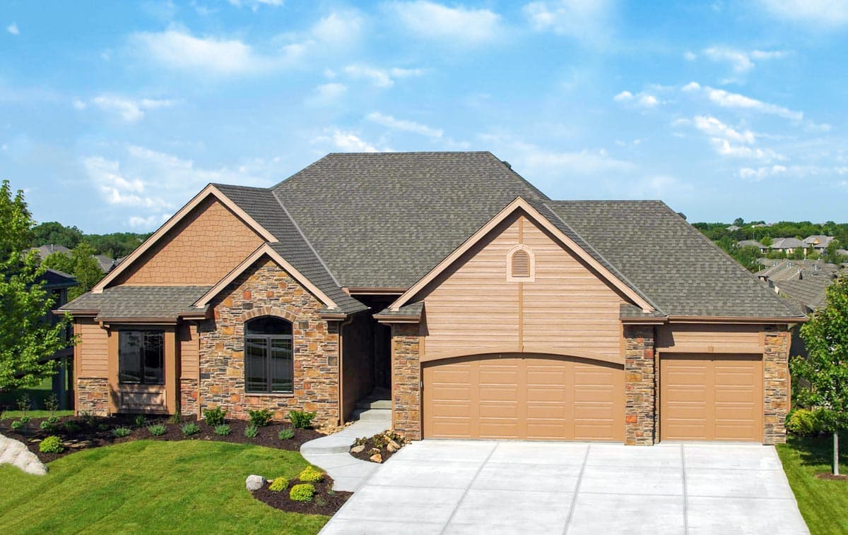 House plan exterior: Ranch-style, multi-level roof, stone and shingle siding, arched window, and 3-car garage.