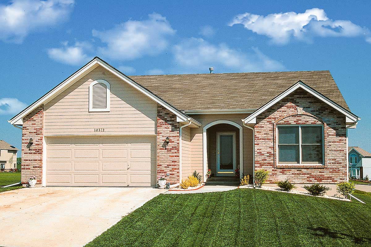 House plan exterior: One-story home with vinyl siding, brick accents, arched window dormer, and attached garage.