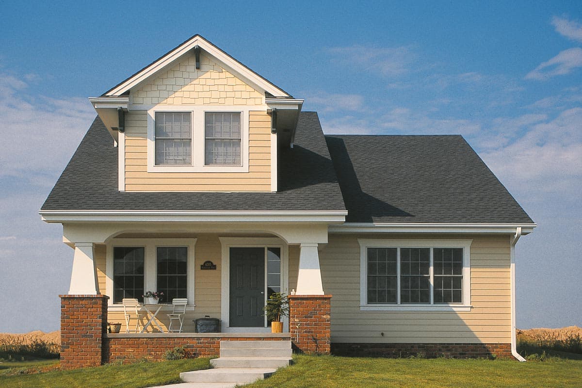 Two-story house plan exterior with gabled dormer, covered porch with brick accents, and double-hung windows.