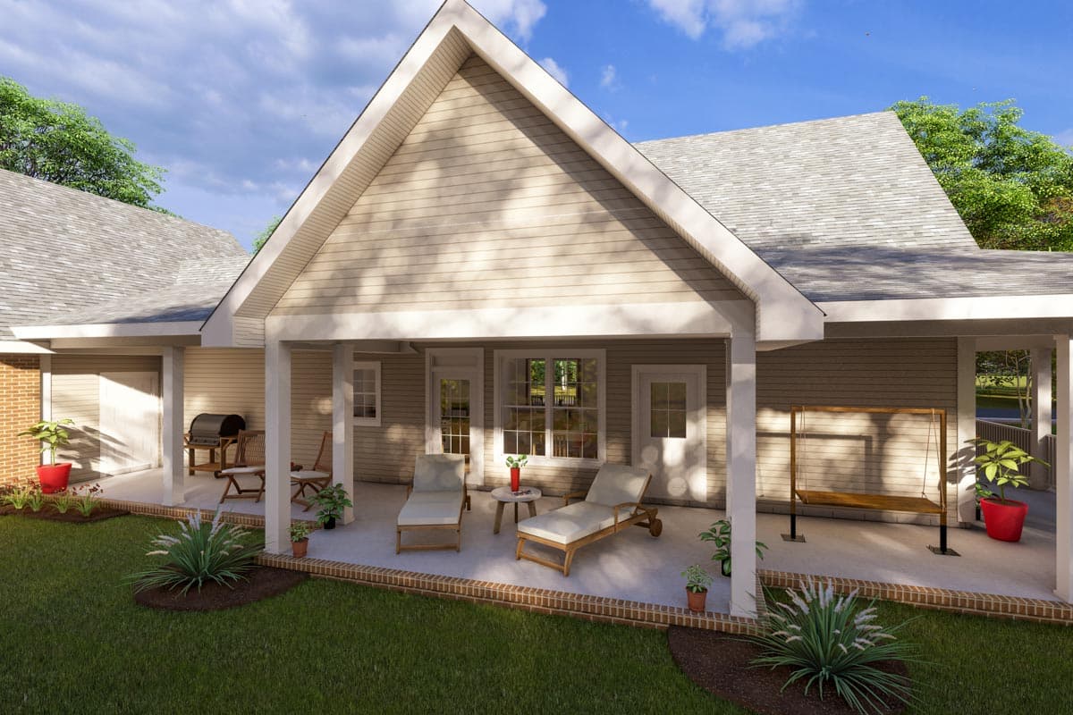 House plan exterior with covered patio featuring chaise lounges, a swing, and a grill area. Gable rooflines and vinyl siding.