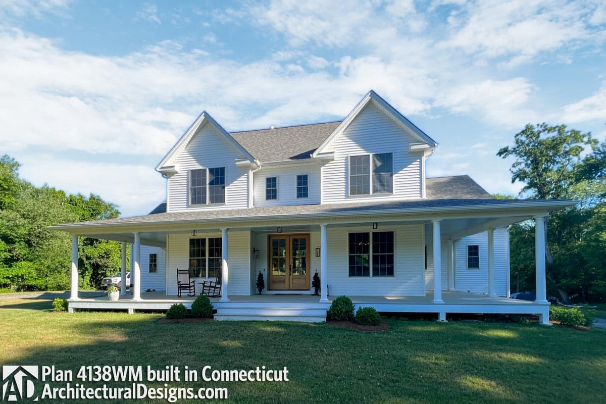 House plan exterior of a two-story Modern Farmhouse with a wraparound porch, gables, and double front doors.