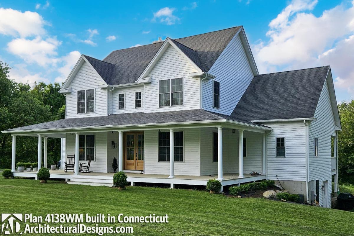 Modern Farmhouse two-story house plan exterior with wrap-around porch, gables, and multiple dormers.