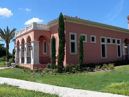 House plan exterior featuring a loggia with arched openings, decorative balustrade, and varied window sizes.
