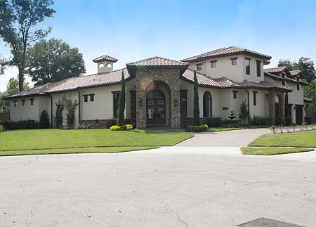 House plan exterior with stone arched entryway, stucco walls, tile roof, and a central cupola.