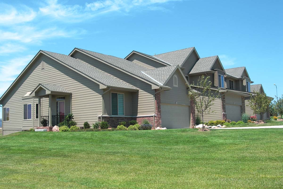 House plan exterior: Contemporary style, multiple gables, dormers, and integrated garage doors.