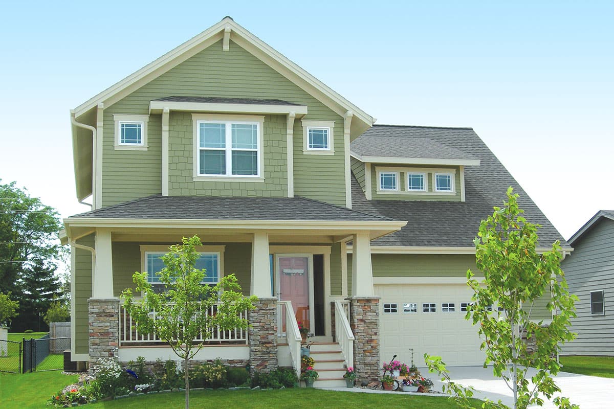 Two-story Modern Farmhouse exterior with gables, dormers, stone-clad porch columns, and a two-car garage.