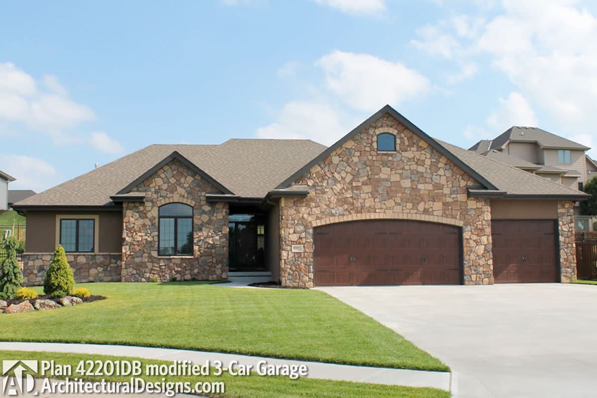 House plan exterior: Ranch-style home with stone facade, arched main entrance, and 3-car garage.
