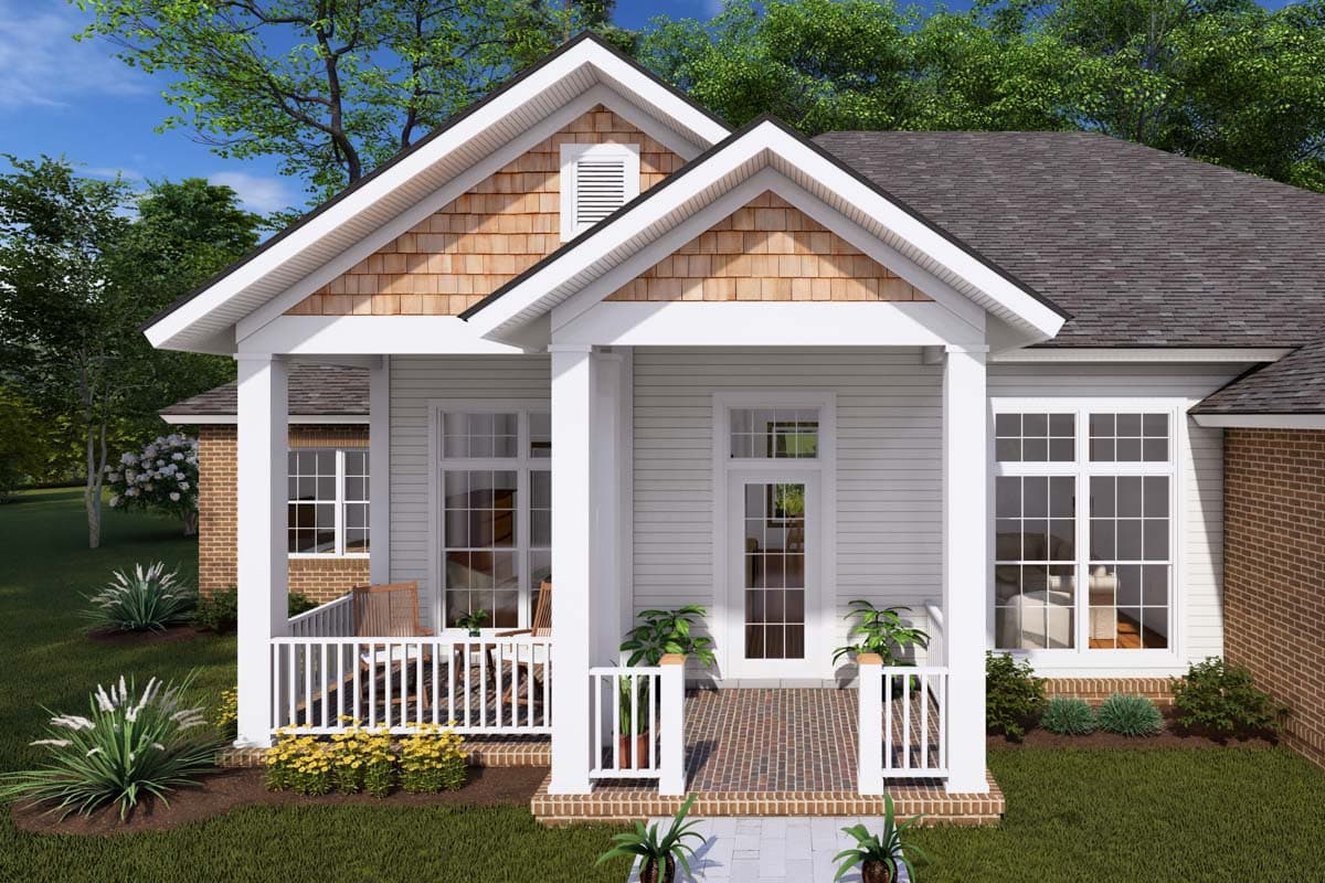 House plan exterior with a prominent front porch, gable roof with cedar shake siding, and brick accents.