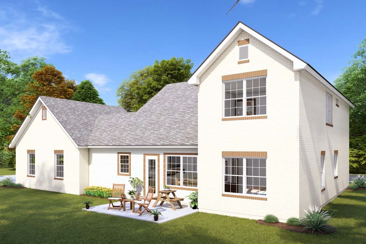 House plan exterior: Two-story white brick home with gables, brick window trim, and a pitched roof. Patio with furniture visible.