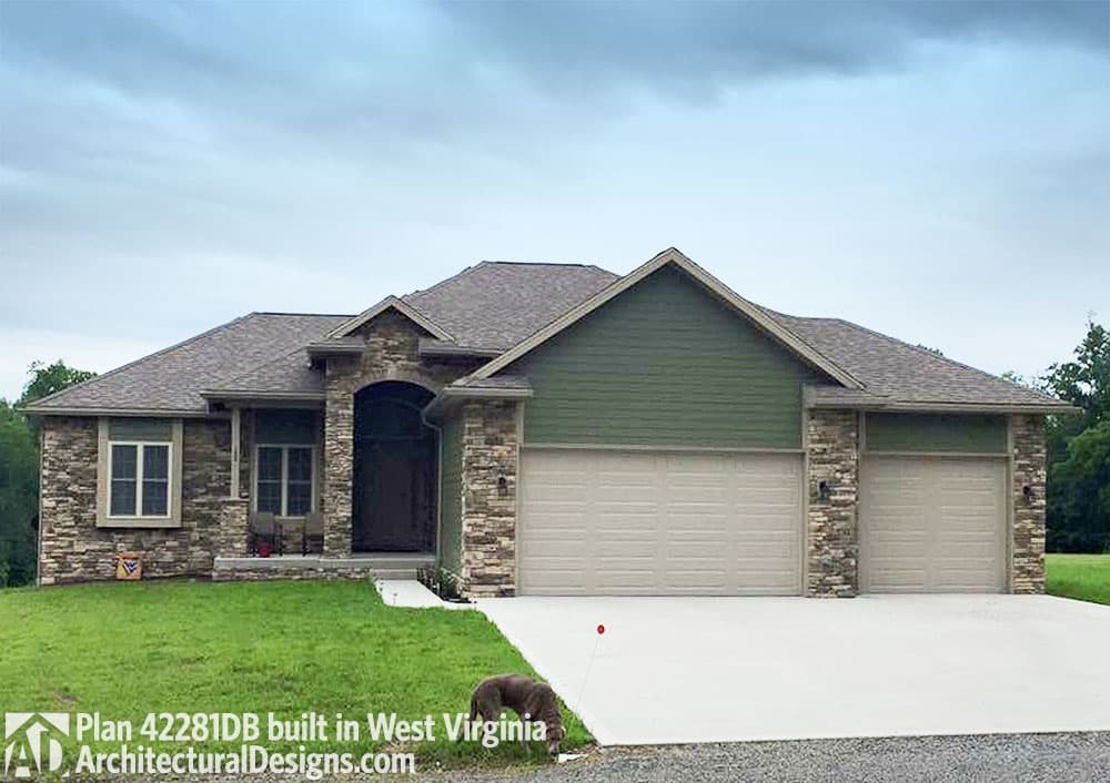 House plan exterior: Ranch style with stone and green siding, arched entryway, and three-car garage.