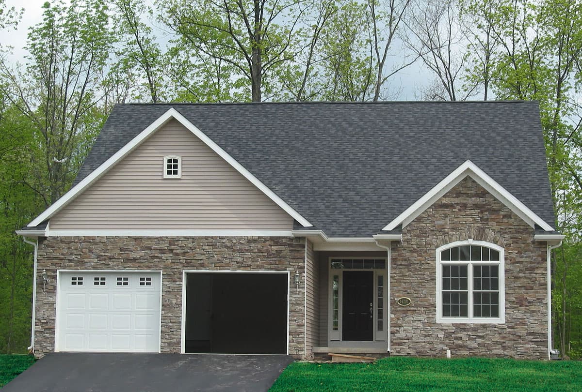 House plan exterior: One-story home with stone veneer, siding, two-car garage, arched window, and gable dormer.