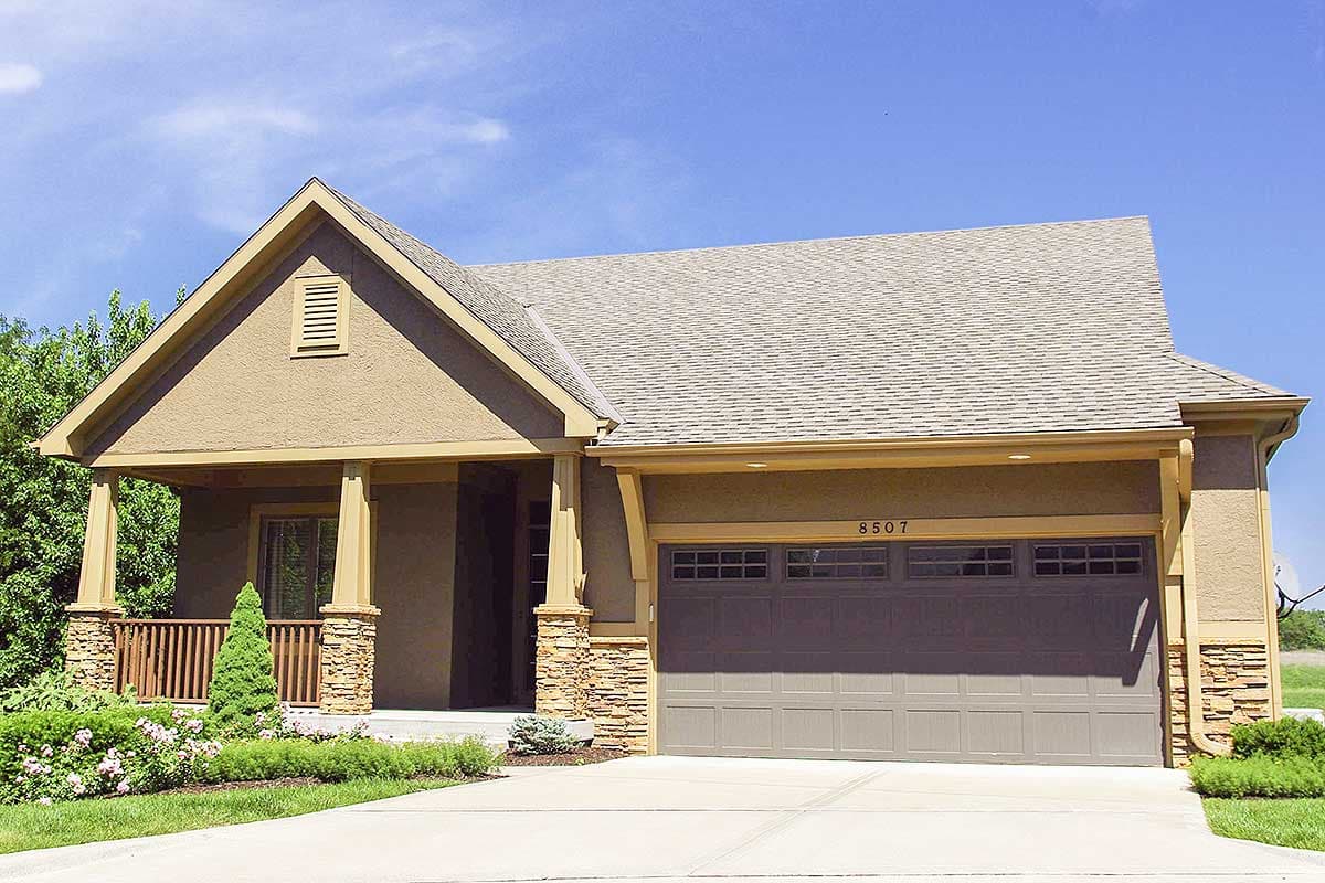 House plan exterior: One-story Modern Farmhouse with covered porch, stone accents, and a two-car garage.