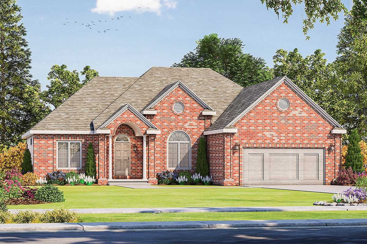 House plan exterior. One-story brick house with a gable roof, arched entry, round attic windows, and an attached two-car garage.