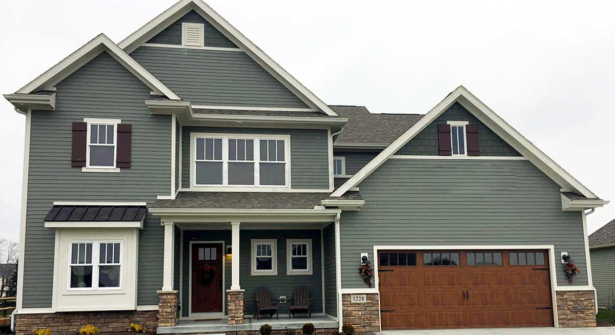 House plan exterior: two-story Modern Farmhouse with gables, covered porch, and attached garage.