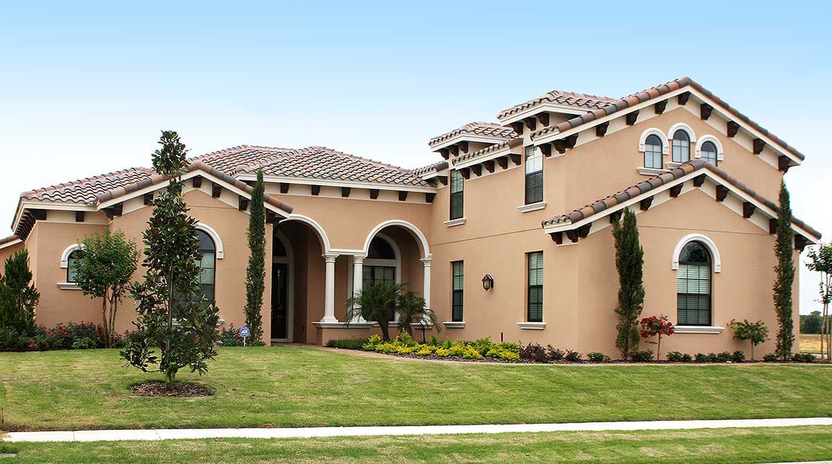 House plan exterior with tiled roof, arched entry with columns, and multiple gables.