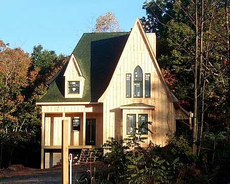 House plan exterior: Gothic Revival style, two stories, steeply pitched roof, gabled dormer, and arched windows.