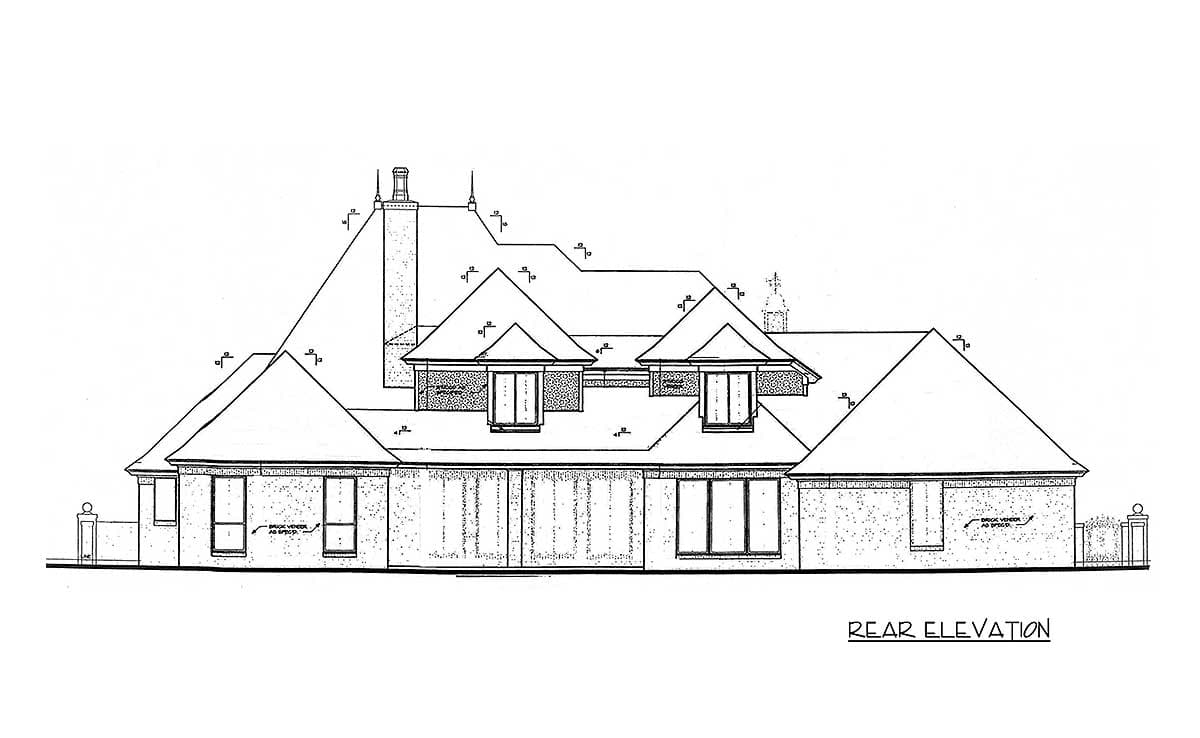 Rear elevation drawing of a house plan with a complex roofline, multiple gables, dormers, and a prominent chimney.
