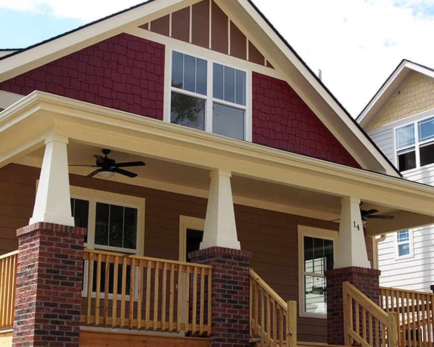 Craftsman style house plan exterior with wraparound porch, gable, dormer, and brick column accents.