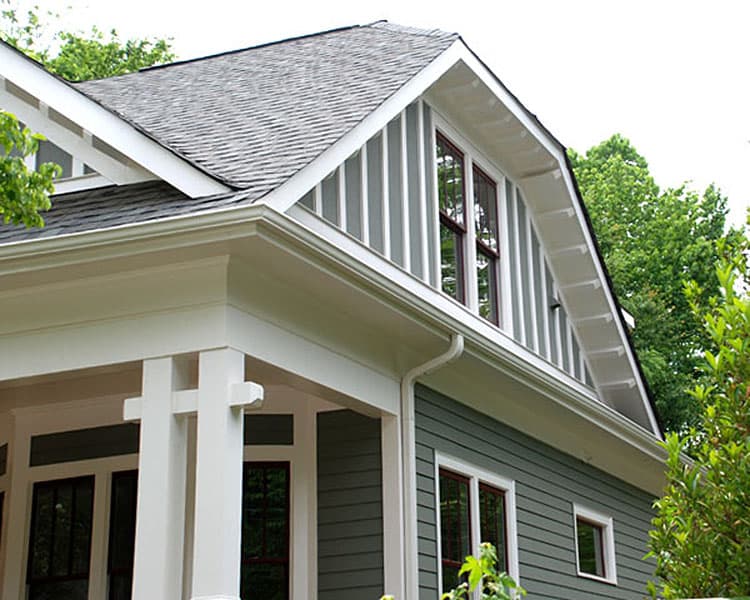 House plan exterior with Craftsman style details: gabled dormers, vertical siding, and exposed rafter tails.