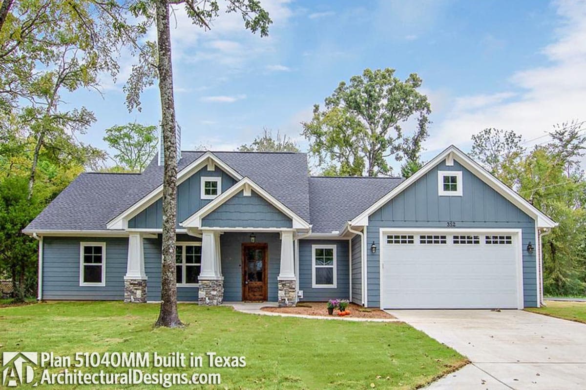 House plan exterior: One-story modern farmhouse with covered front porch, gables, dormers, and attached garage.