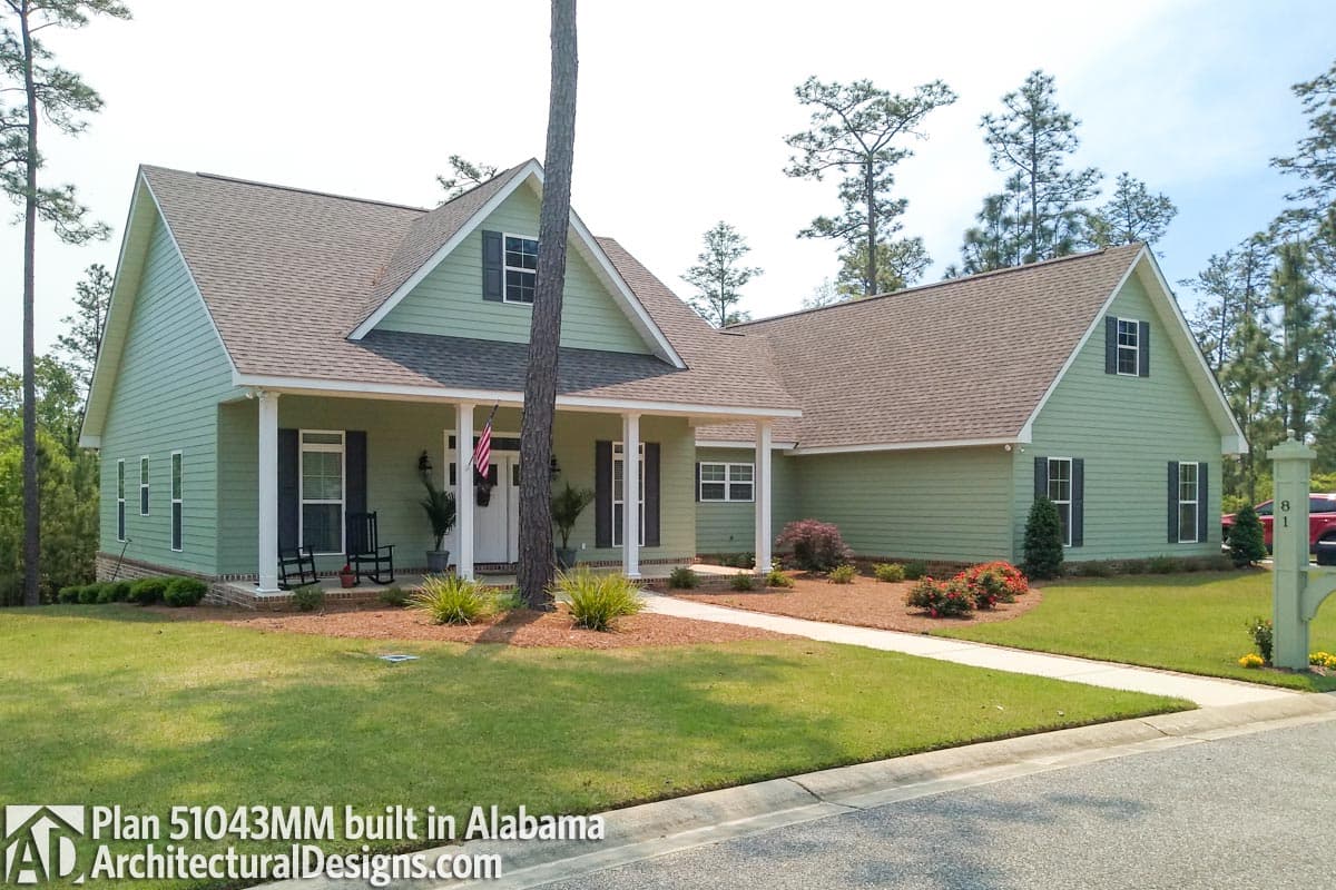 House plan exterior: one-story Modern Farmhouse with gabled dormers, wide covered front porch with columns, and lap siding.