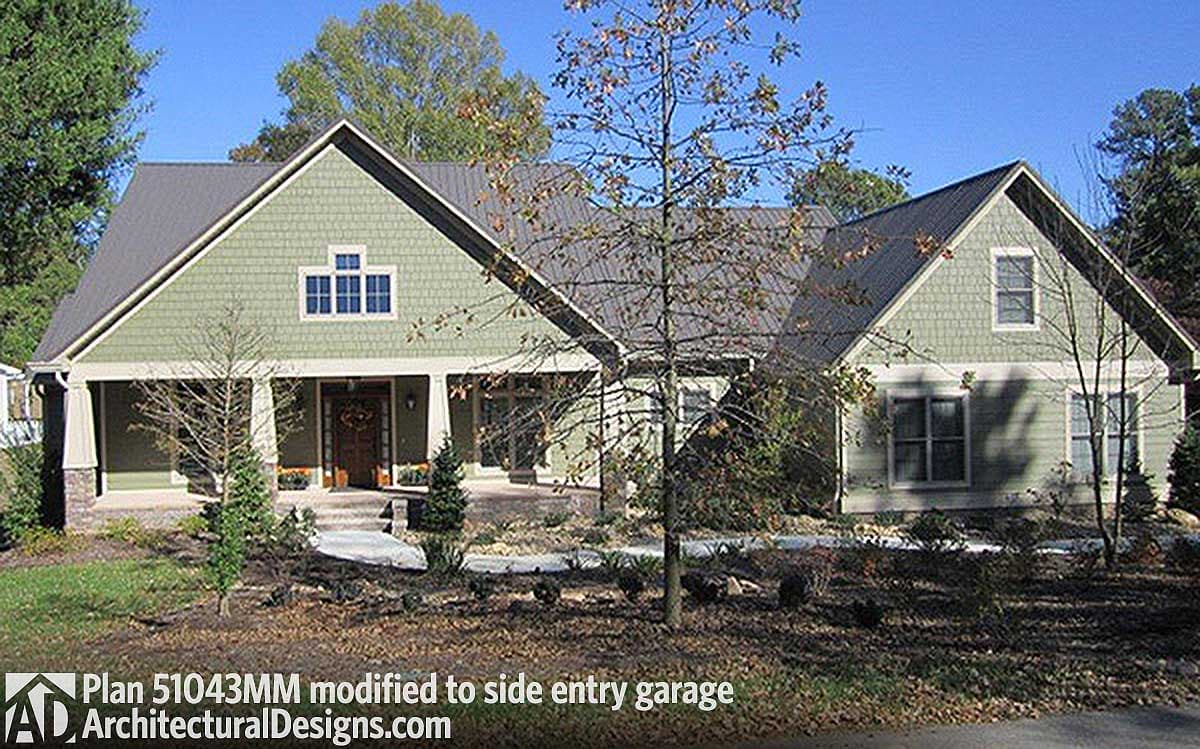 House plan exterior: Ranch style, covered front porch with stone accents, gabled dormer, and side entry garage.