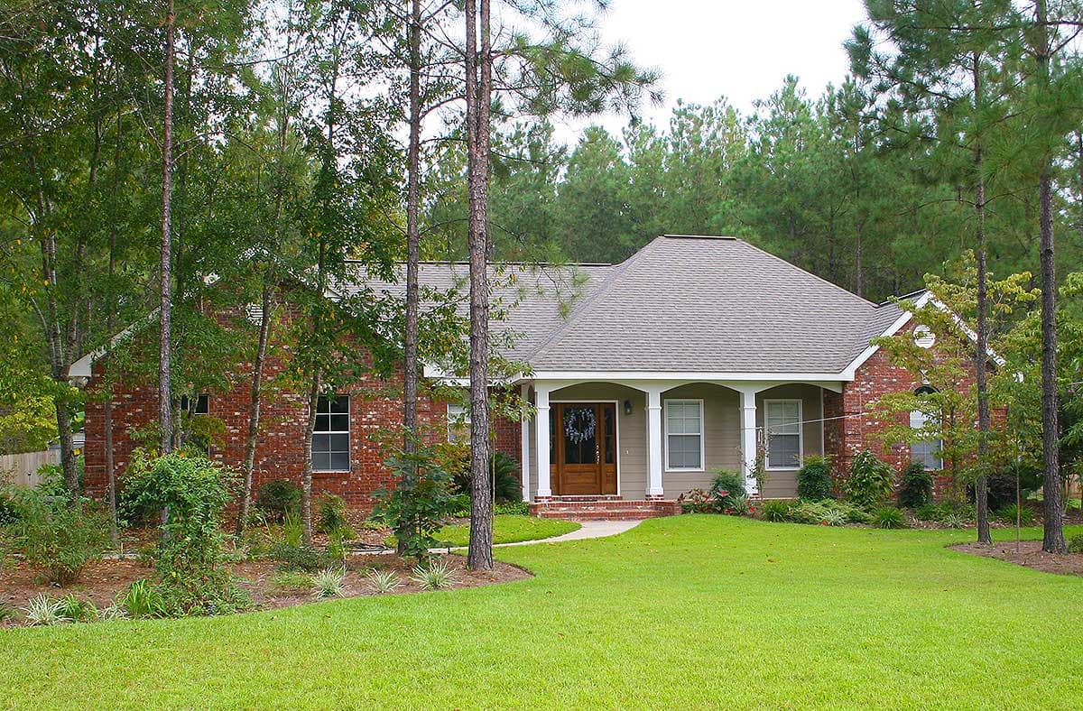 Ranch style house plan exterior with brick accents, a covered entry porch with columns, and a prominent gable.