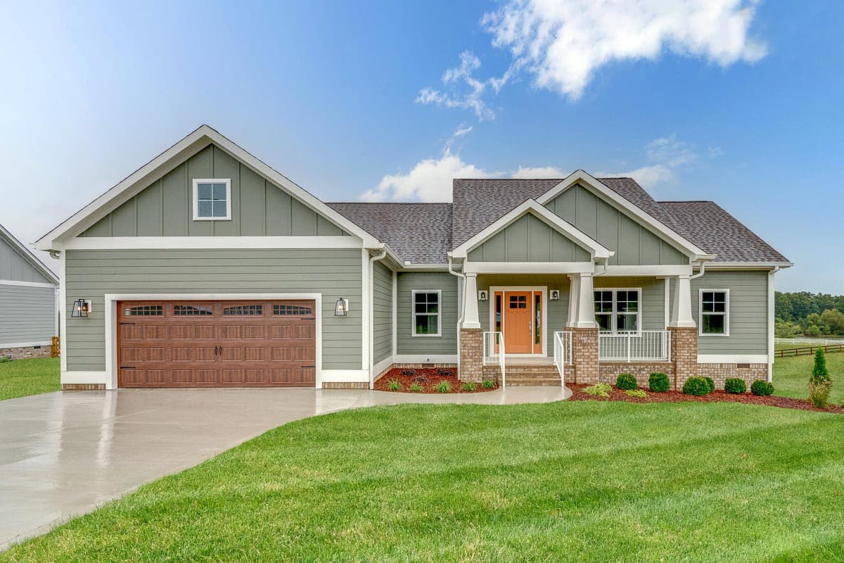 House plan exterior. Craftsman-style, one-story home with front-facing gables, a covered porch with columns, and a two-car garage.