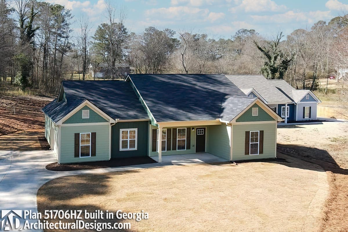 House plan exterior: one-story ranch with gables, covered entry porch, and double garage.