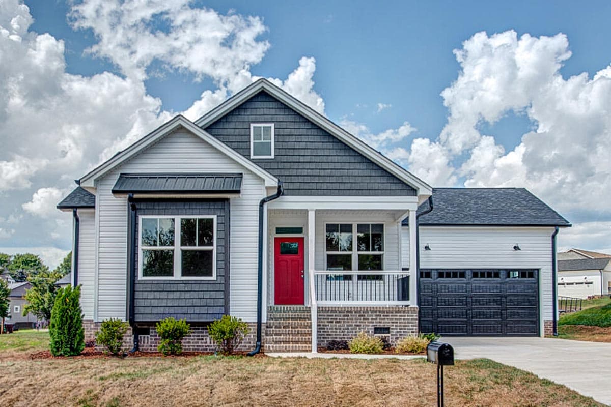 House plan exterior: Modern Farmhouse style, one story, with a covered front porch, prominent gables, and attached side-entry garage.
