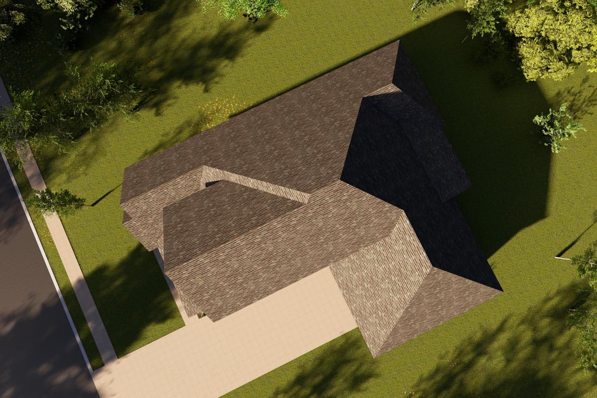 House plan exterior aerial view showing complex rooflines and a driveway leading to an attached garage.