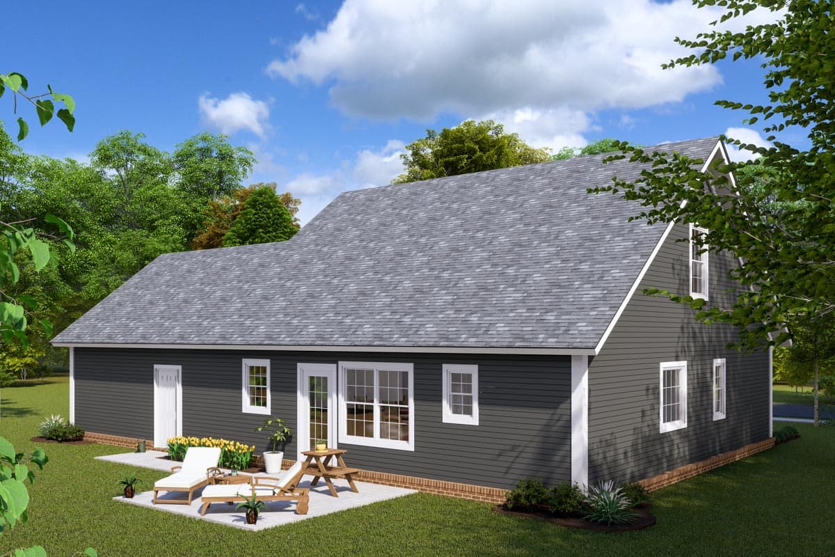 House plan exterior, a two-story home with dark siding, gabled dormers, and a patio with lounge chairs.