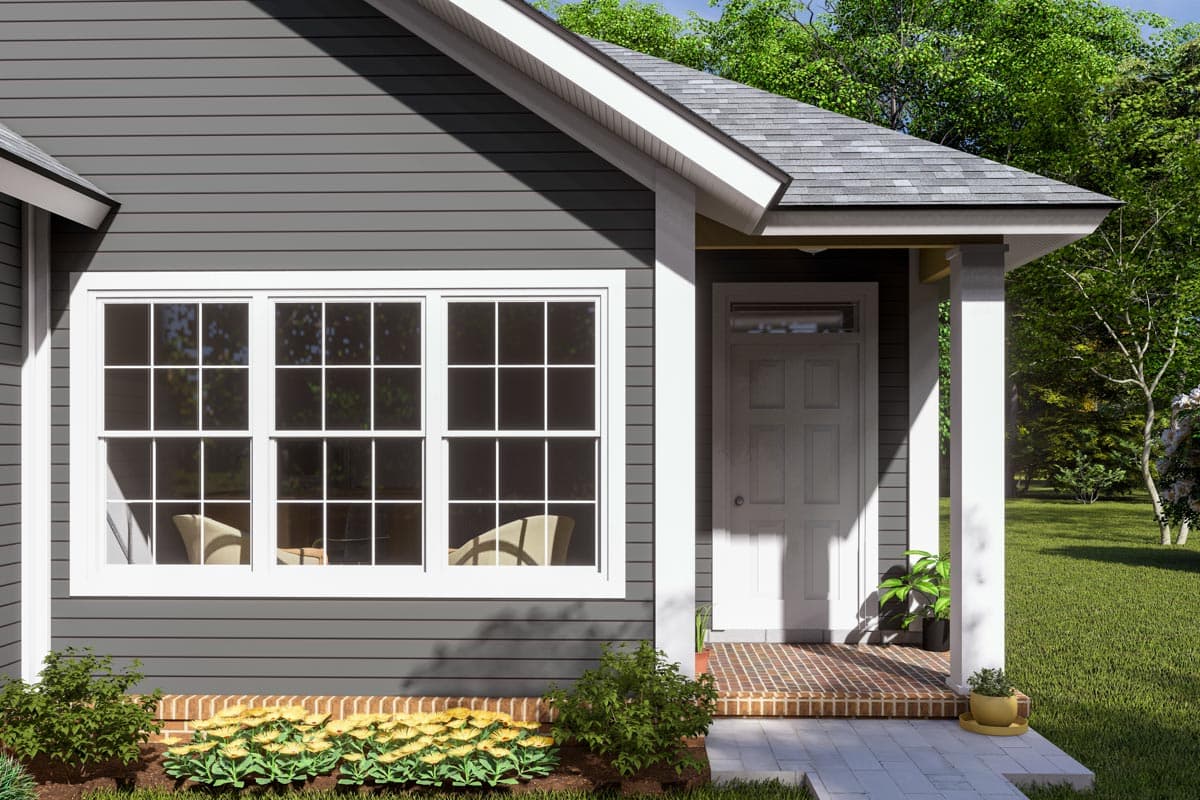 House plan exterior with gray siding, white-trimmed windows, a white-paneled door, and a covered front porch.
