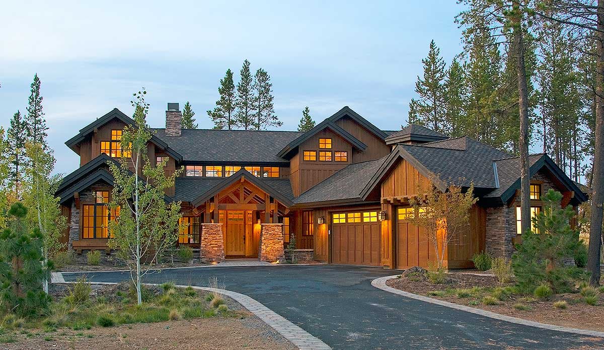 Craftsman style house plan exterior with stone pillars, multiple gables, wood siding, and attached garage.
