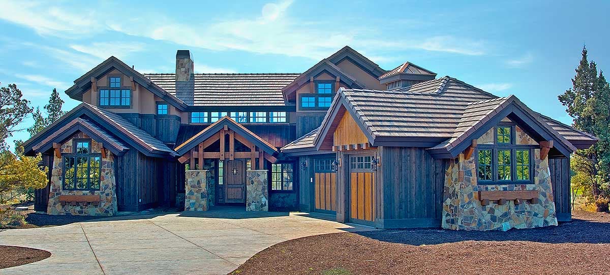 House plan exterior showing a multi-story residence with stone and wood siding, multiple gables, and a covered entryway.