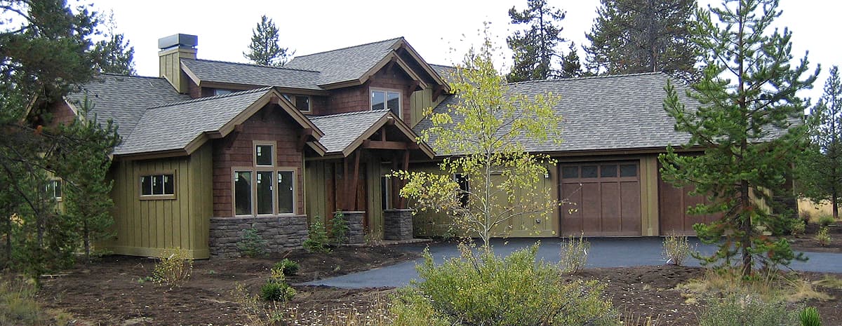 House plan exterior featuring stacked stone accents, prominent gables, covered entry, and a side-facing garage. Architectural style appears rustic.