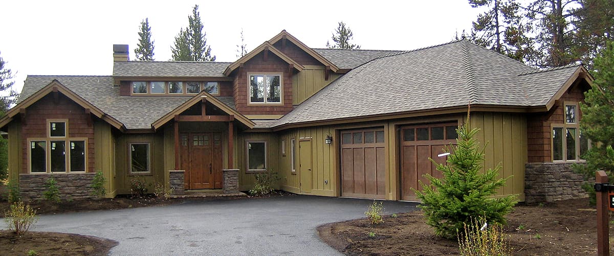 House plan exterior, Craftsman style, two stories, covered entry, dormers, and a three-car garage.