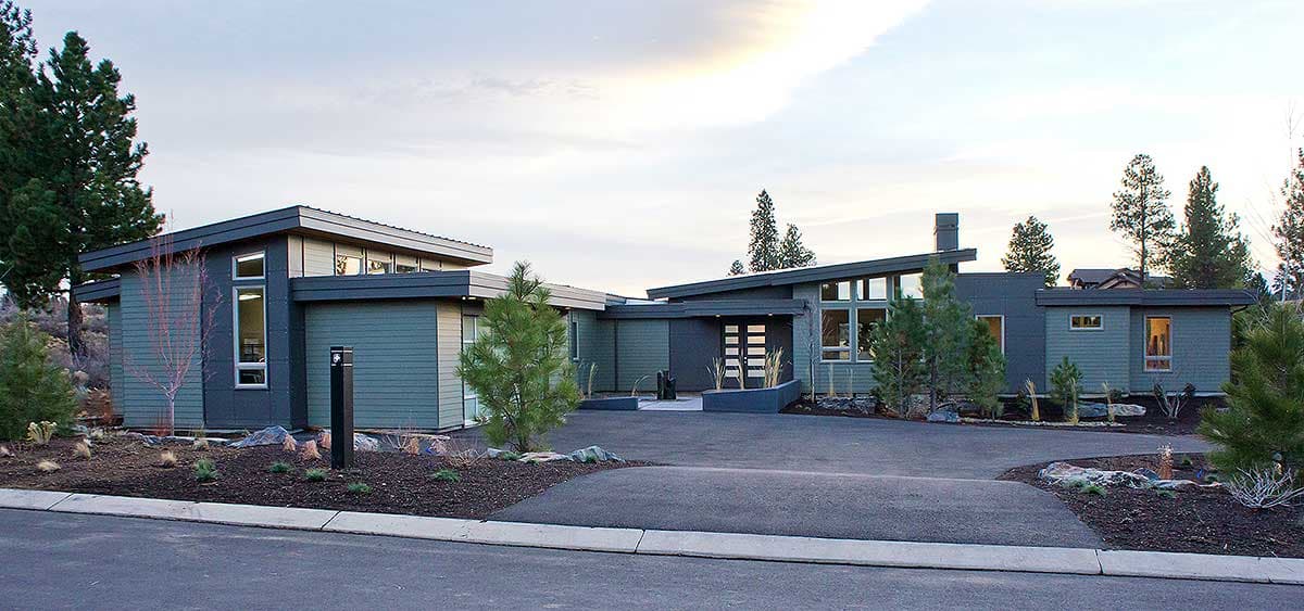 Modern house plan exterior with multiple gables, cantilevered rooflines, and large windows.