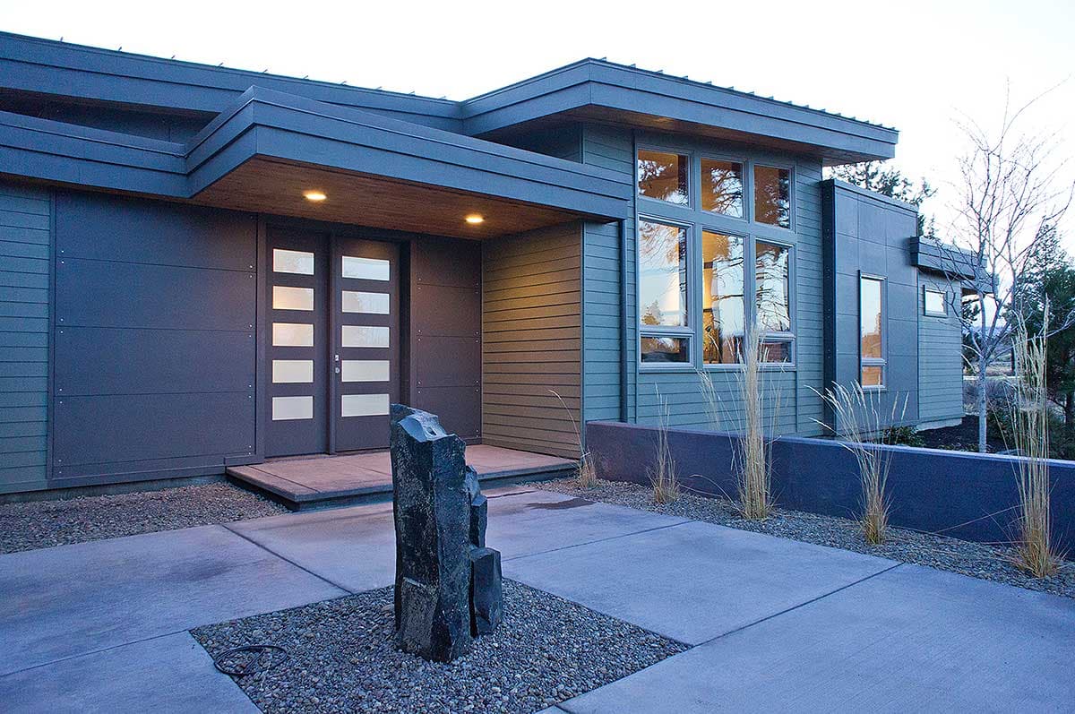Modern house plan exterior with horizontal siding, large windows, covered entryway with double doors, and flat rooflines.