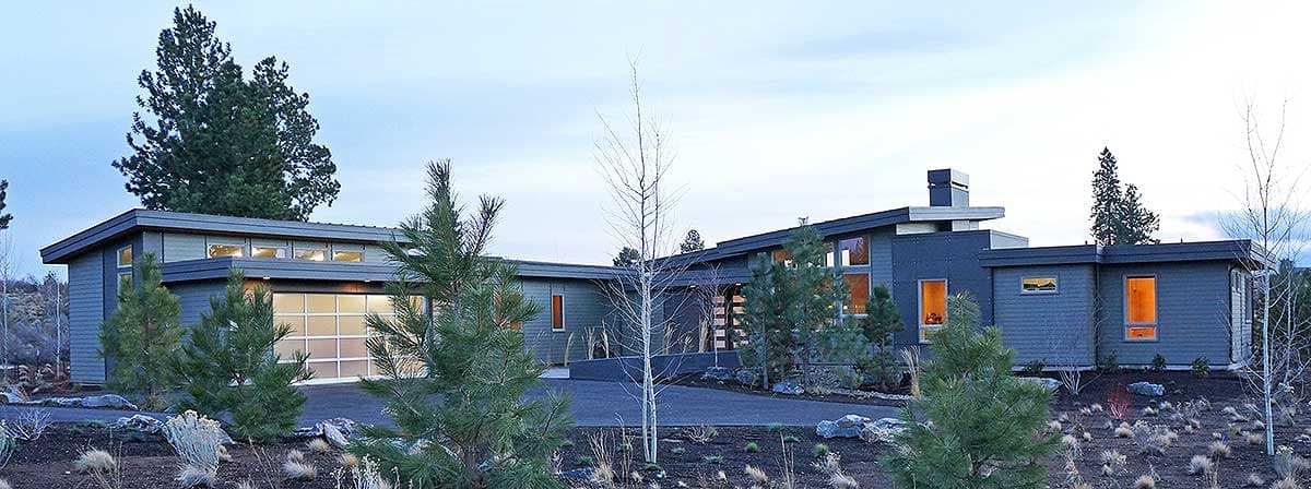 Modern house plan exterior with low-pitched roof, large windows, and attached garage. Features angular rooflines and horizontal siding.