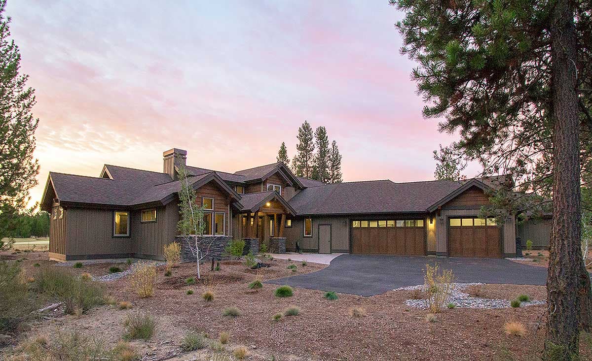 House plan exterior featuring Craftsman-style design. Two-story with multiple gables, a covered entryway, and a side-entry garage.