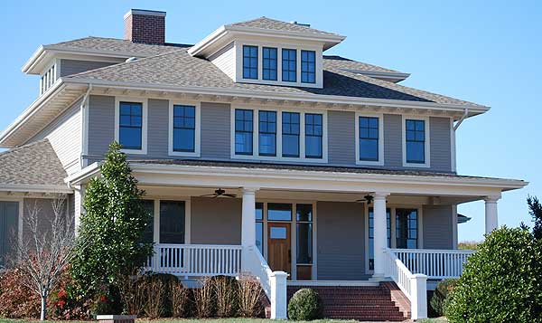 Craftsman style house plan exterior with a prominent dormer, wide porch with columns, and multiple gables.