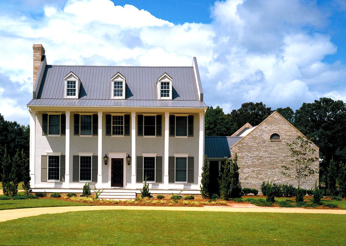 House plan exterior: two-story traditional style with pedimented dormers, metal roof, brick chimney, and a central columned portico.