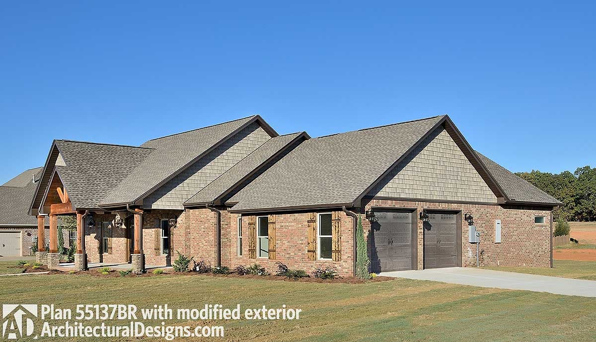 House plan exterior with brick facade, exposed beam porch, dual garage doors, and prominent gables.